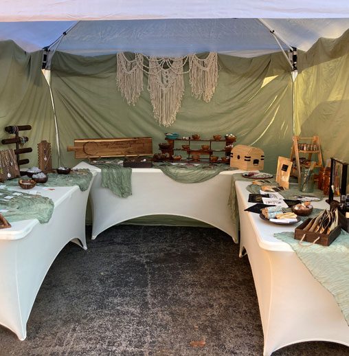 A tent with tables and chairs set up for an event.