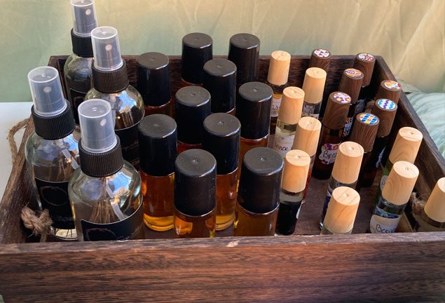 A wooden box filled with lots of bottles and jars.