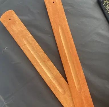 A pair of wooden sticks sitting on top of a table.