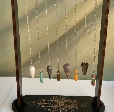 A display of various necklaces hanging from chains.