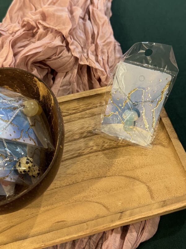 A wooden bowl and a plastic bag on top of a table.