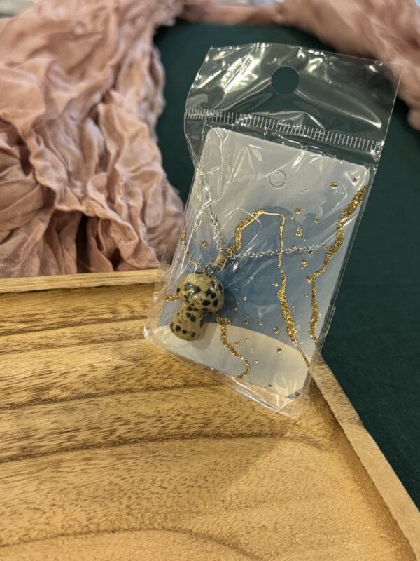 A small animal sitting in a bag on top of a table.