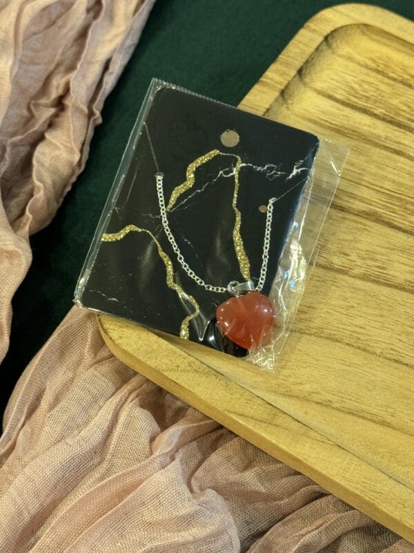 A package of jewelry sitting on top of a wooden table.