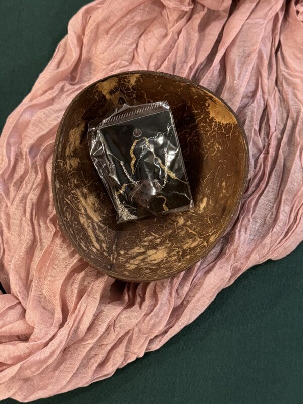 A bowl with a bag of chocolate on top