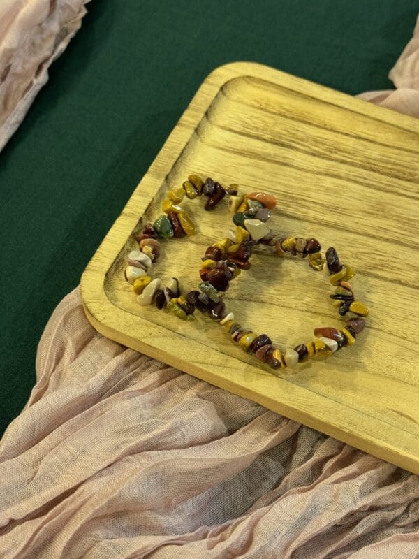 A wooden board with beads on it