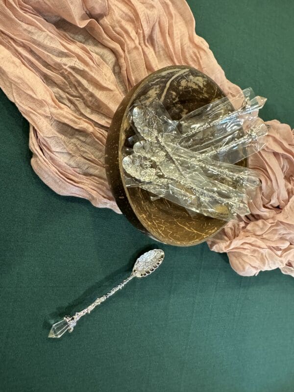 A spoon and bowl on top of a cloth.