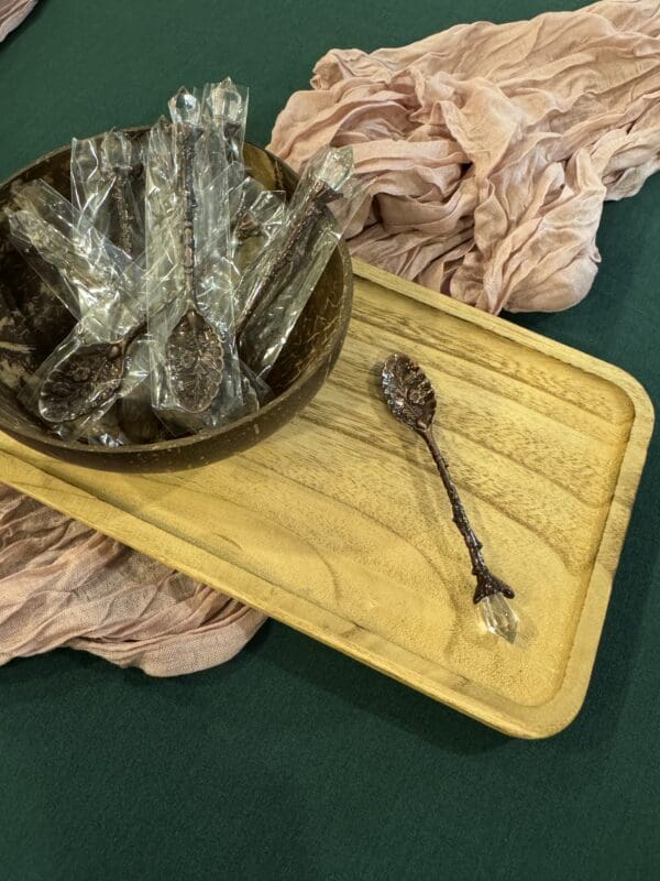 A bowl and spoon on a wooden tray.