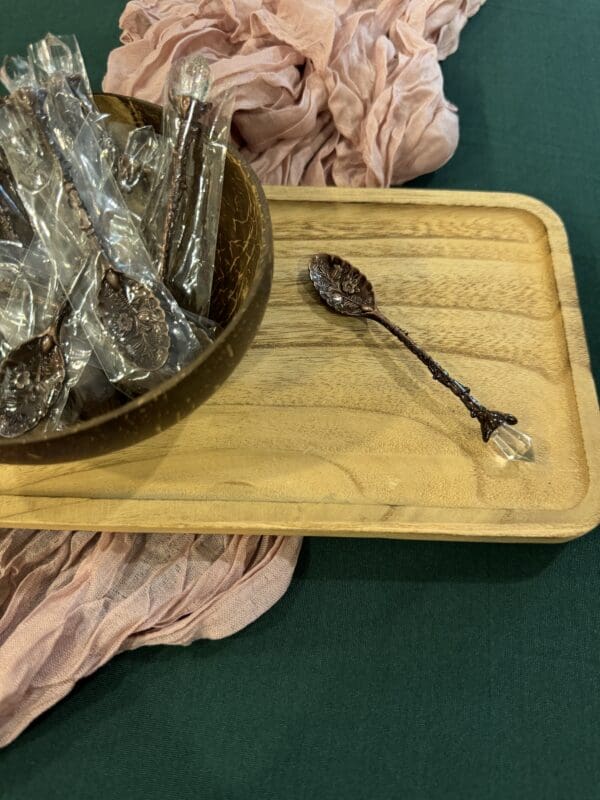 A wooden tray with a bowl and spoon on it