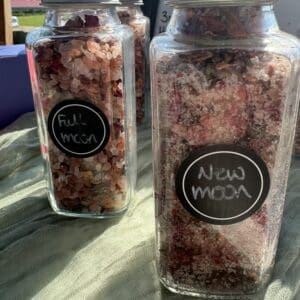 A couple of jars filled with food on top of a table.